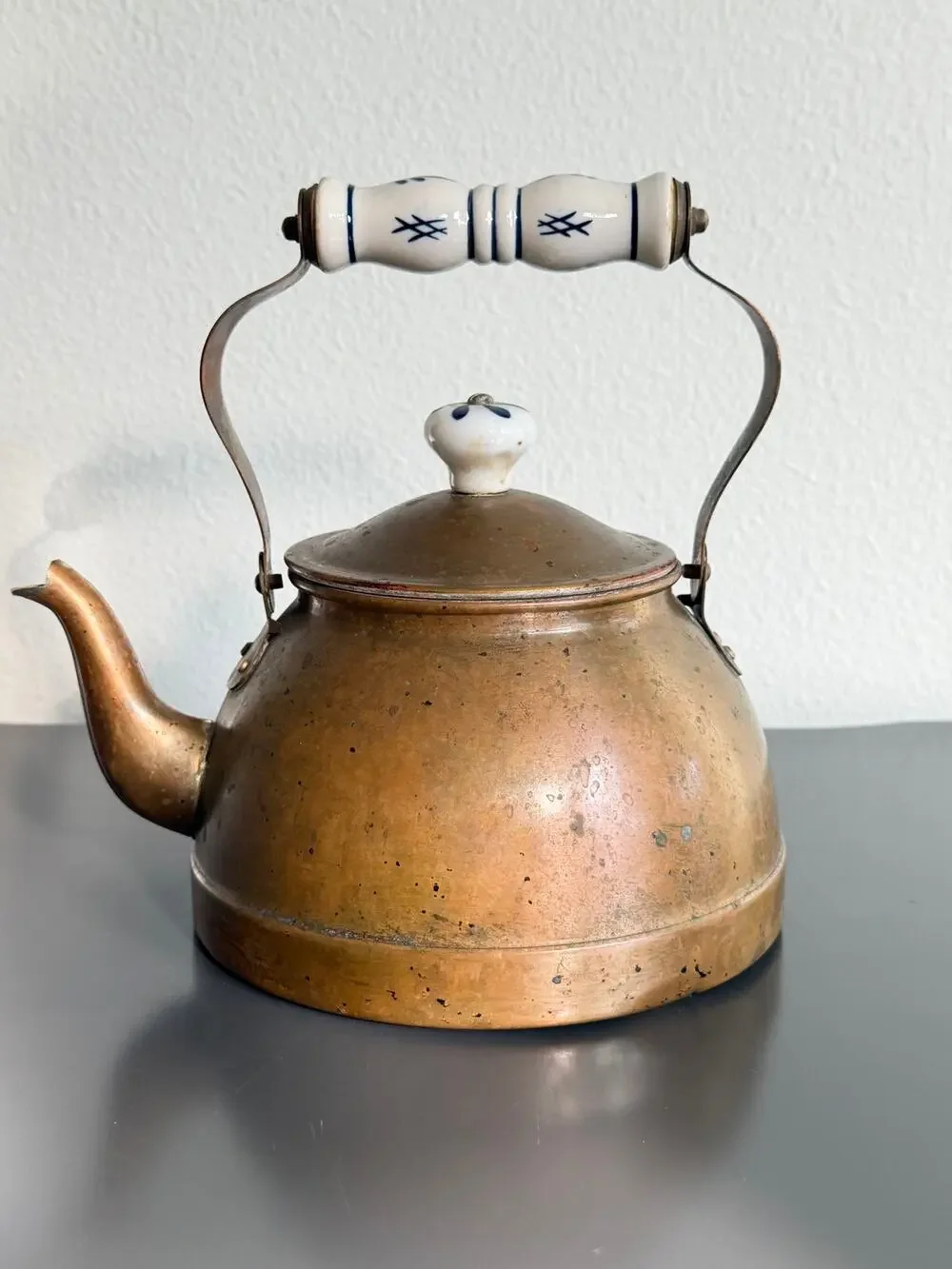Vintage copper tea kettle with hand-painted blue and white porcelain handle lid